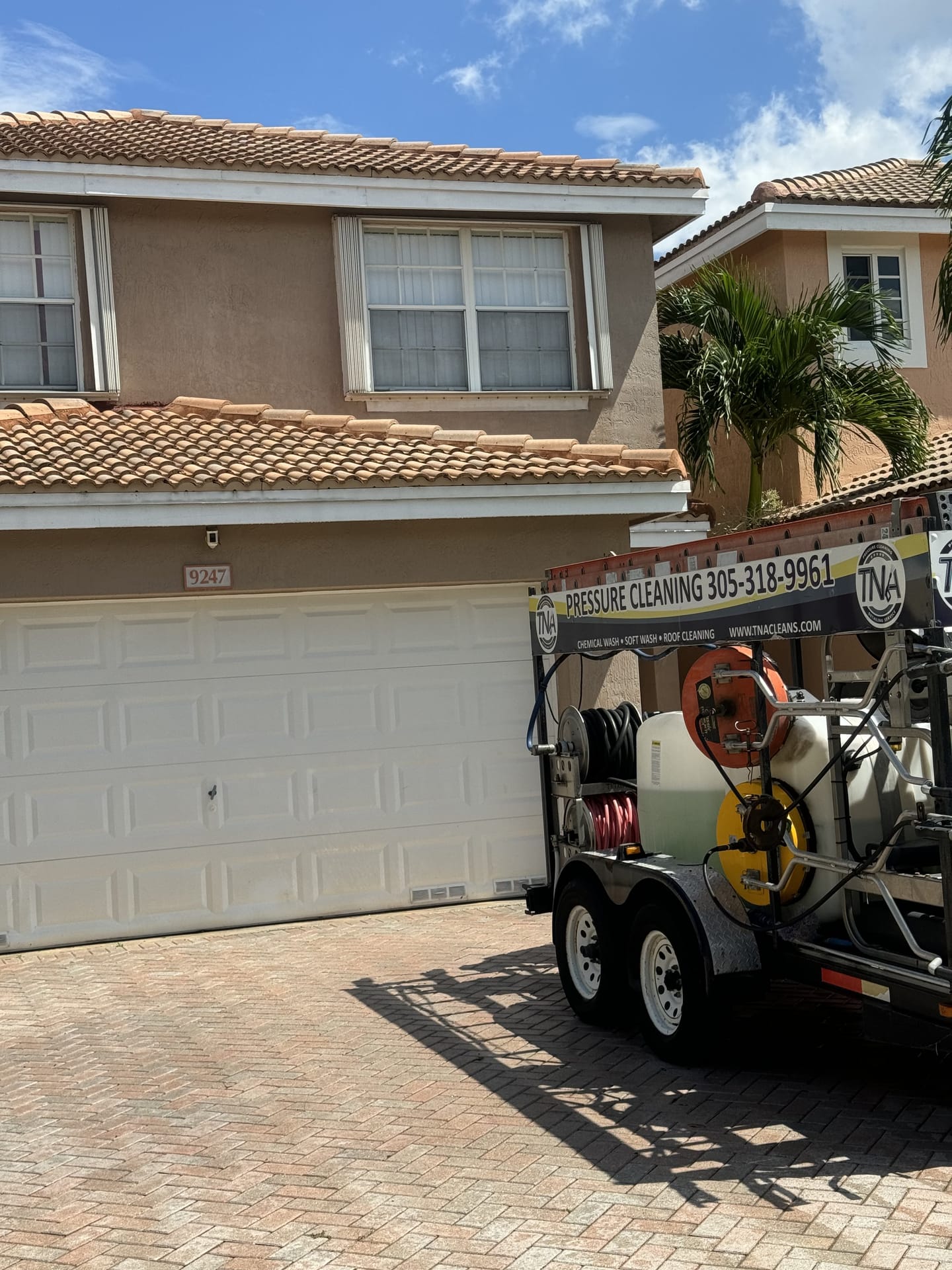 TNA pressure cleaning trailer parked for a roof wash