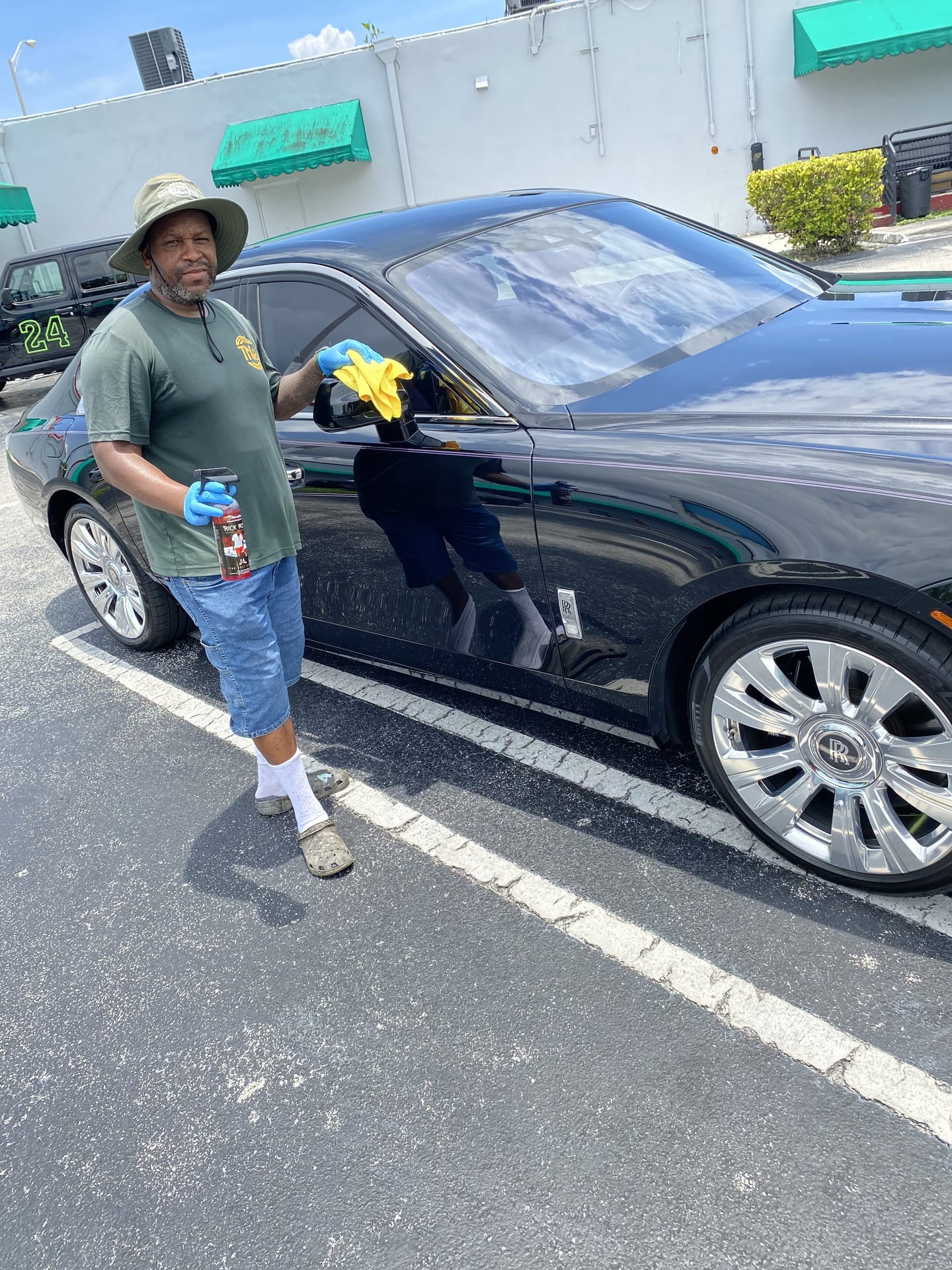 Hand-detailing a black Cadillac on location
