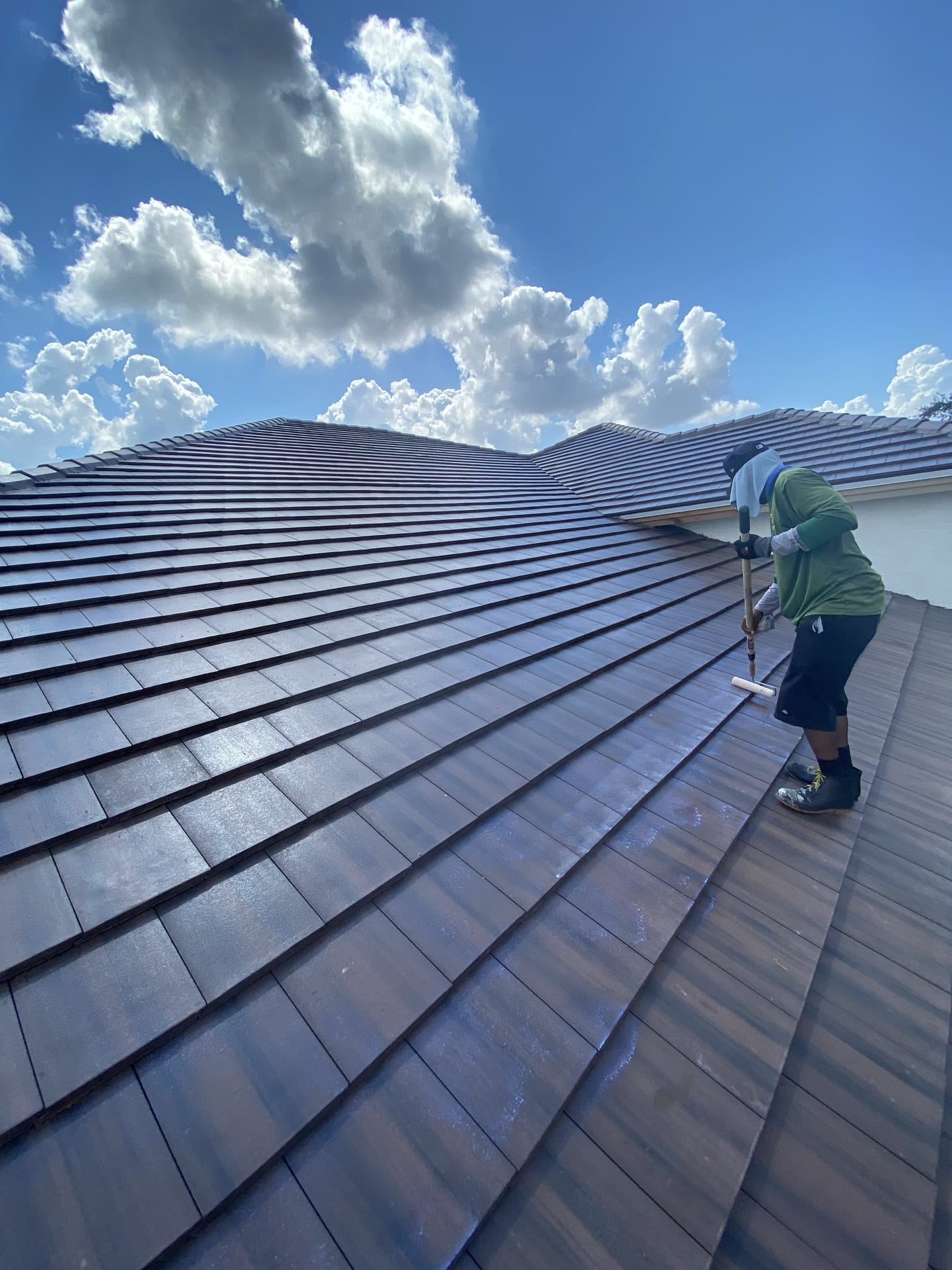 Applying protective roof coating to cleaned tile