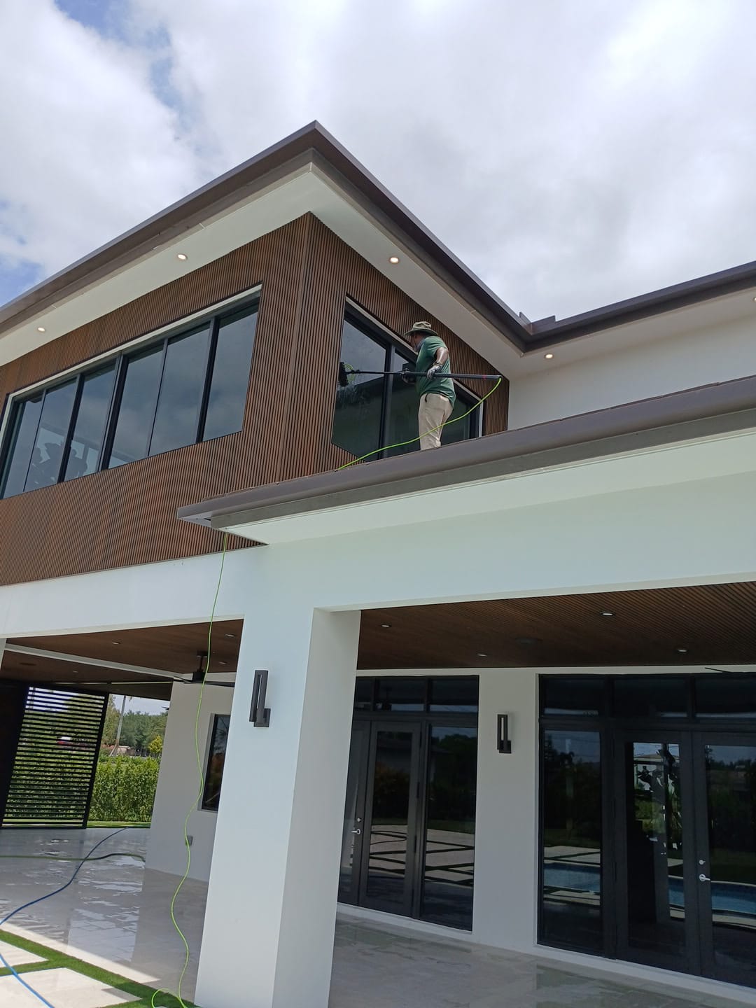 Soft washing the exterior of a modern luxury home