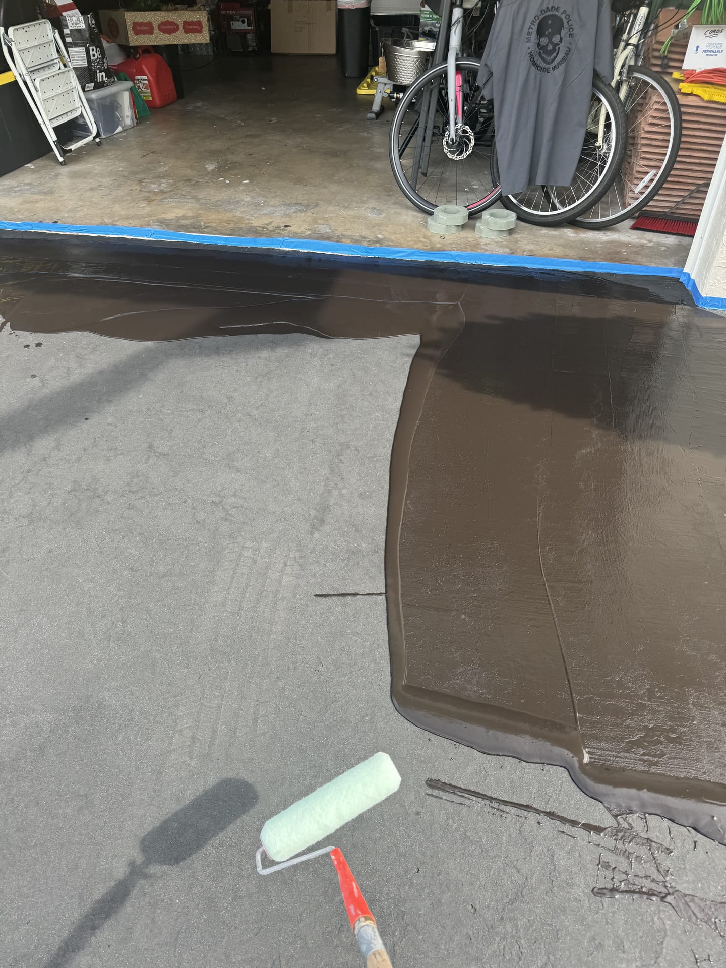 Applying sealant to a residential driveway